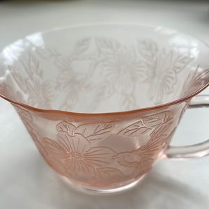 Delicate pink tea glass with floral design.